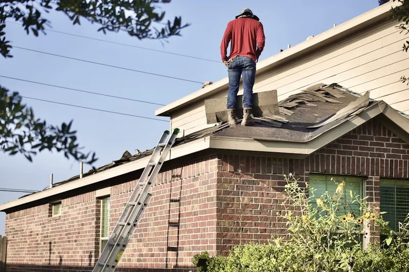 Professional roofer working on a residential roof in Maplewood Park